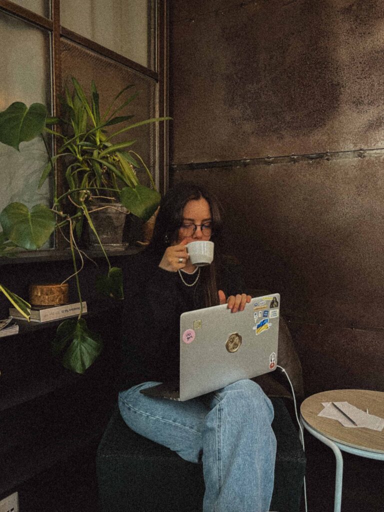 Intern with laptop and drinking coffee