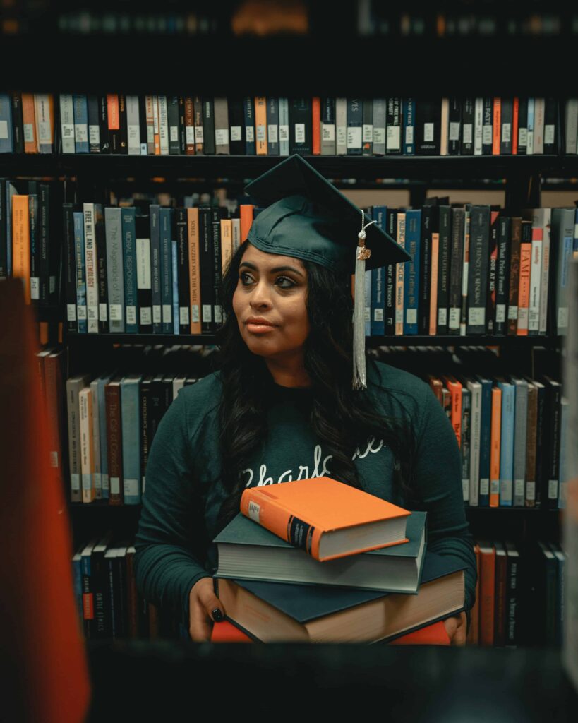 Woman carrying books in library