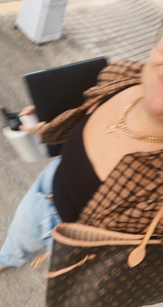 Girl holding computer and bag while walking