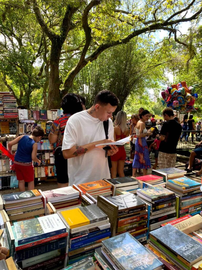 man reading books outside