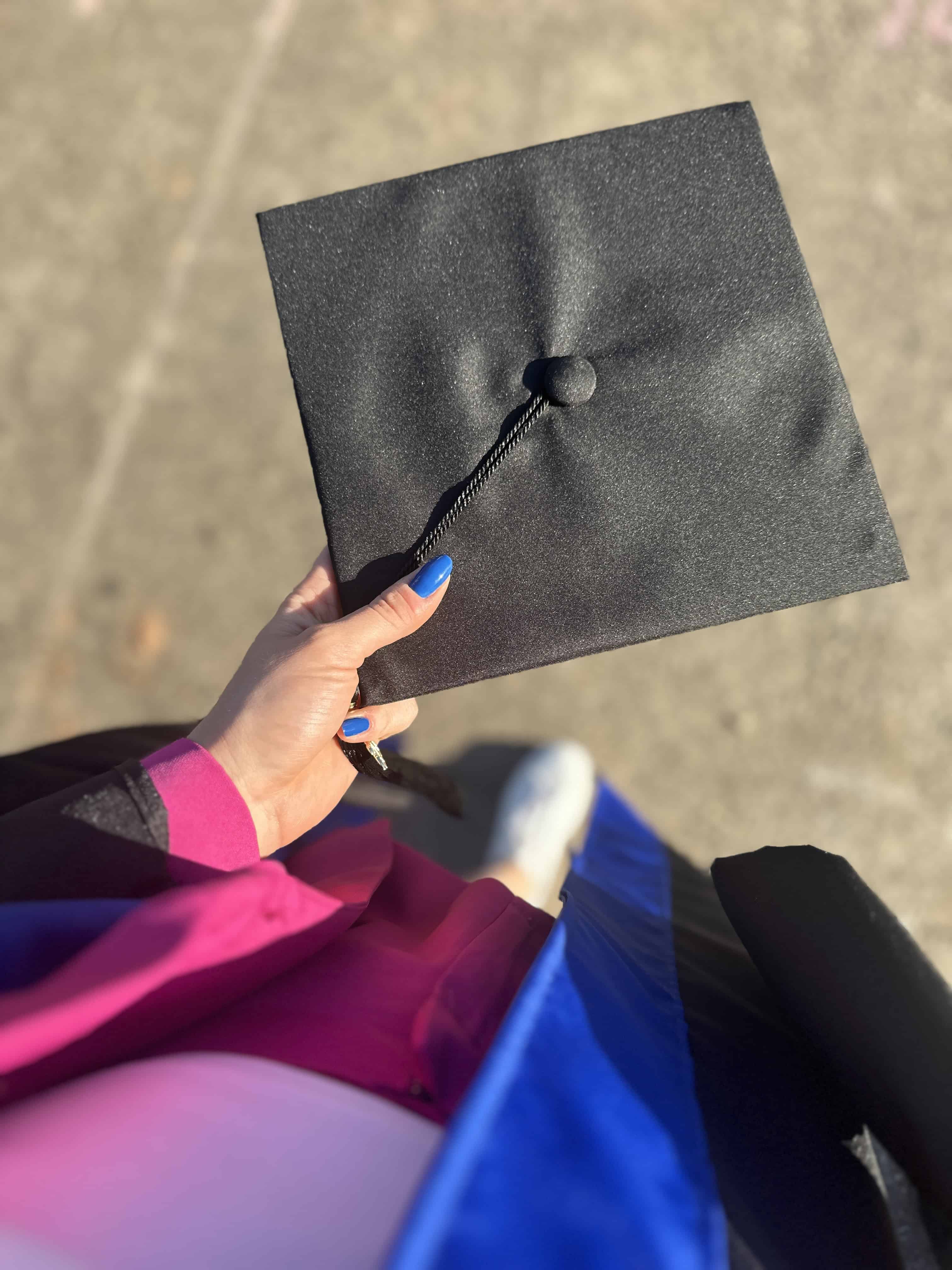 woman holding graduation cap