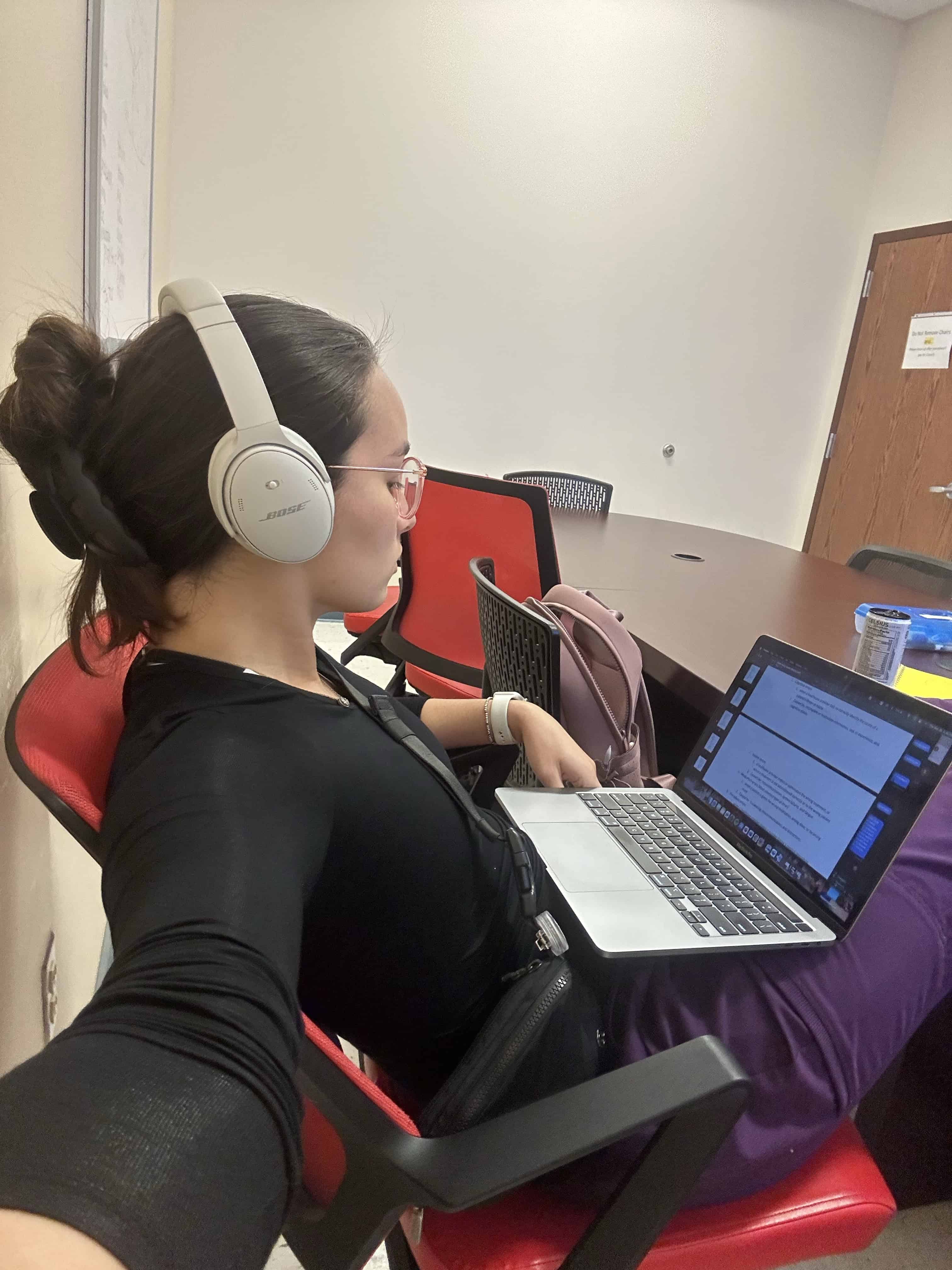 Girl studying at desk with laptop