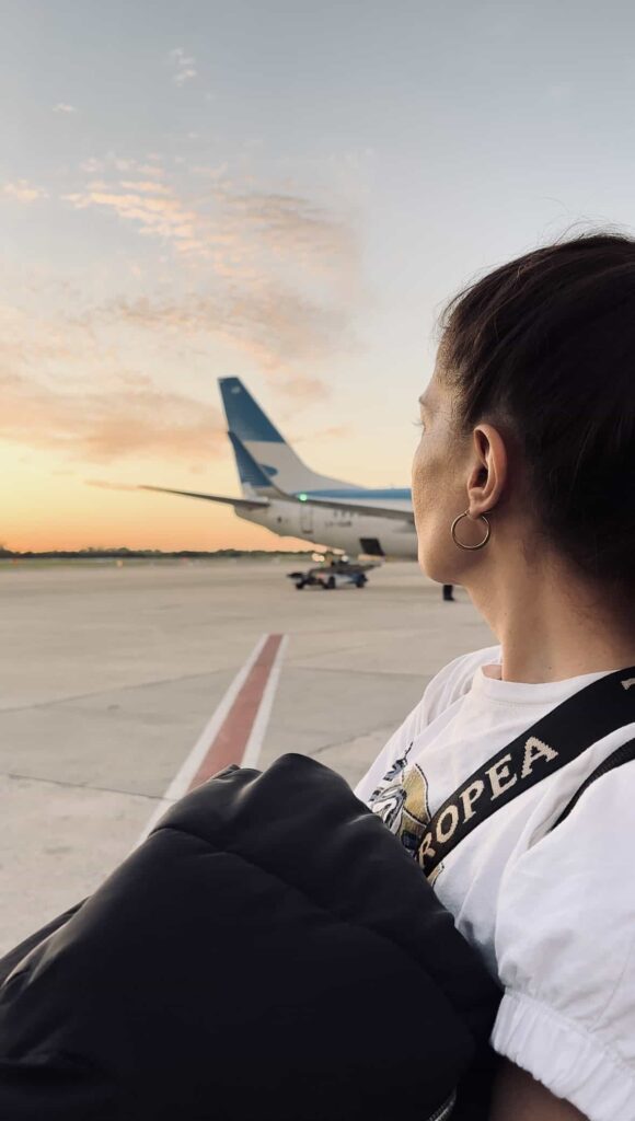 woman standing in front of plane