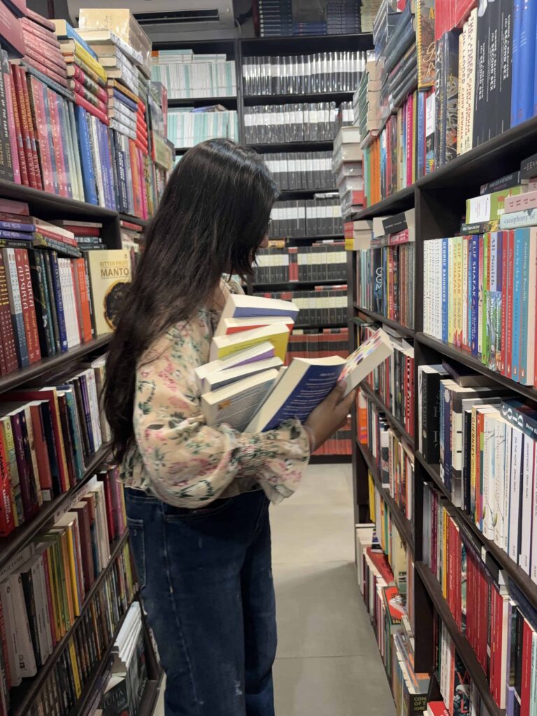 Girl carrying books in library