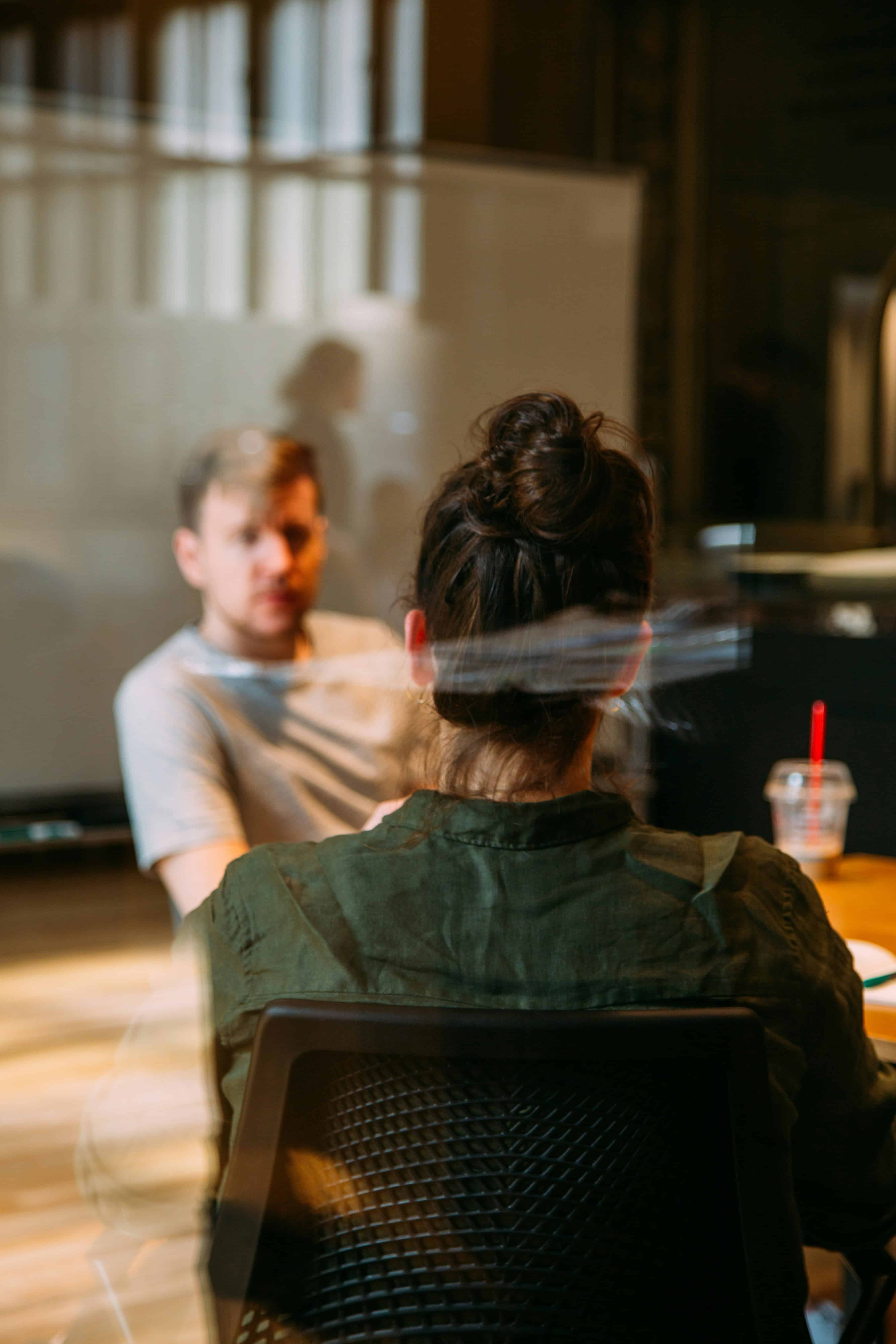 Woman and man sitting in conference room talking